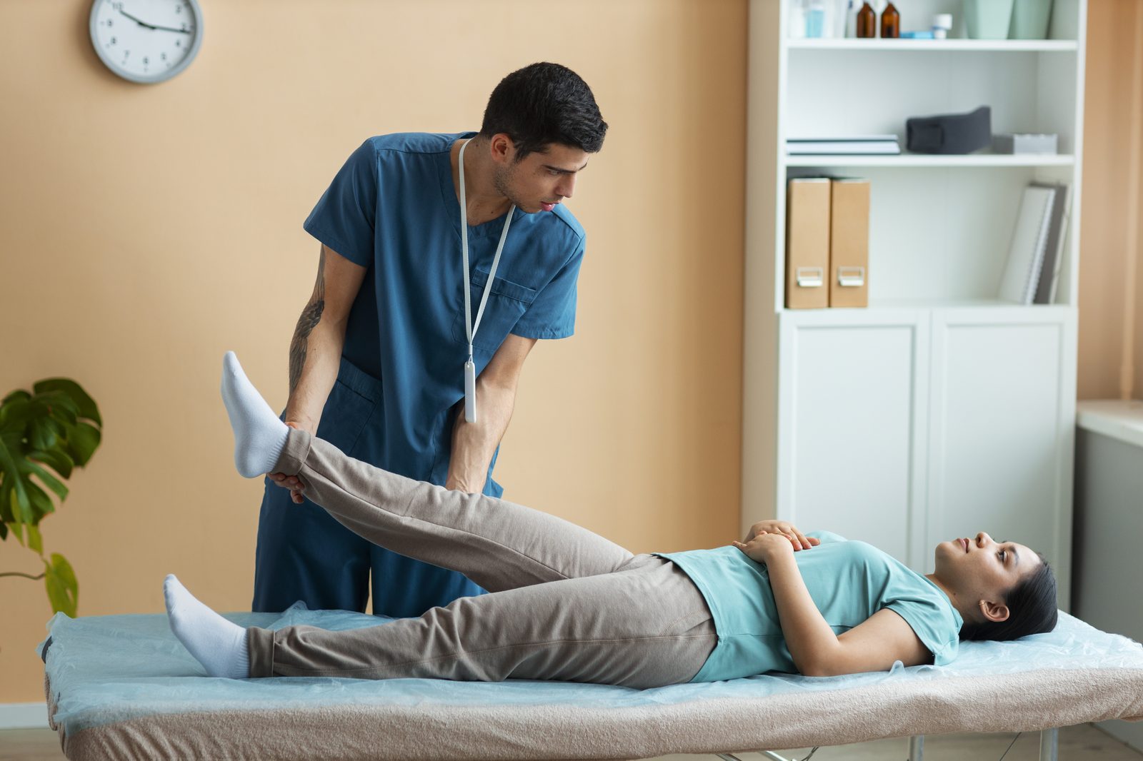 Physiotherapist supporting a patient's home exercise